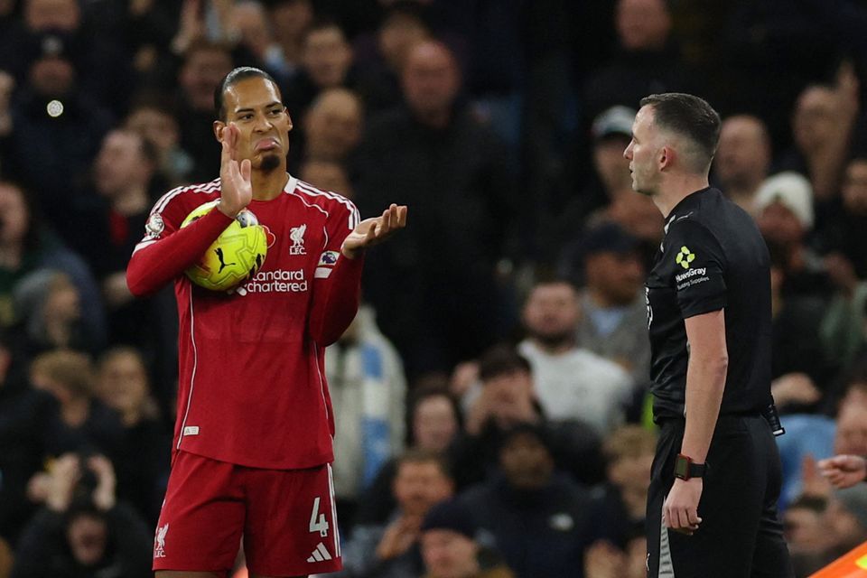 Liverpool's Virgil van Dijk gestures to referee Chris Kavanagh